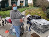 Silvia with clothing and backpacks at Thasnkgiving outreach - Nov 2020