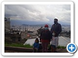 Family in front of destroyed neighborhood